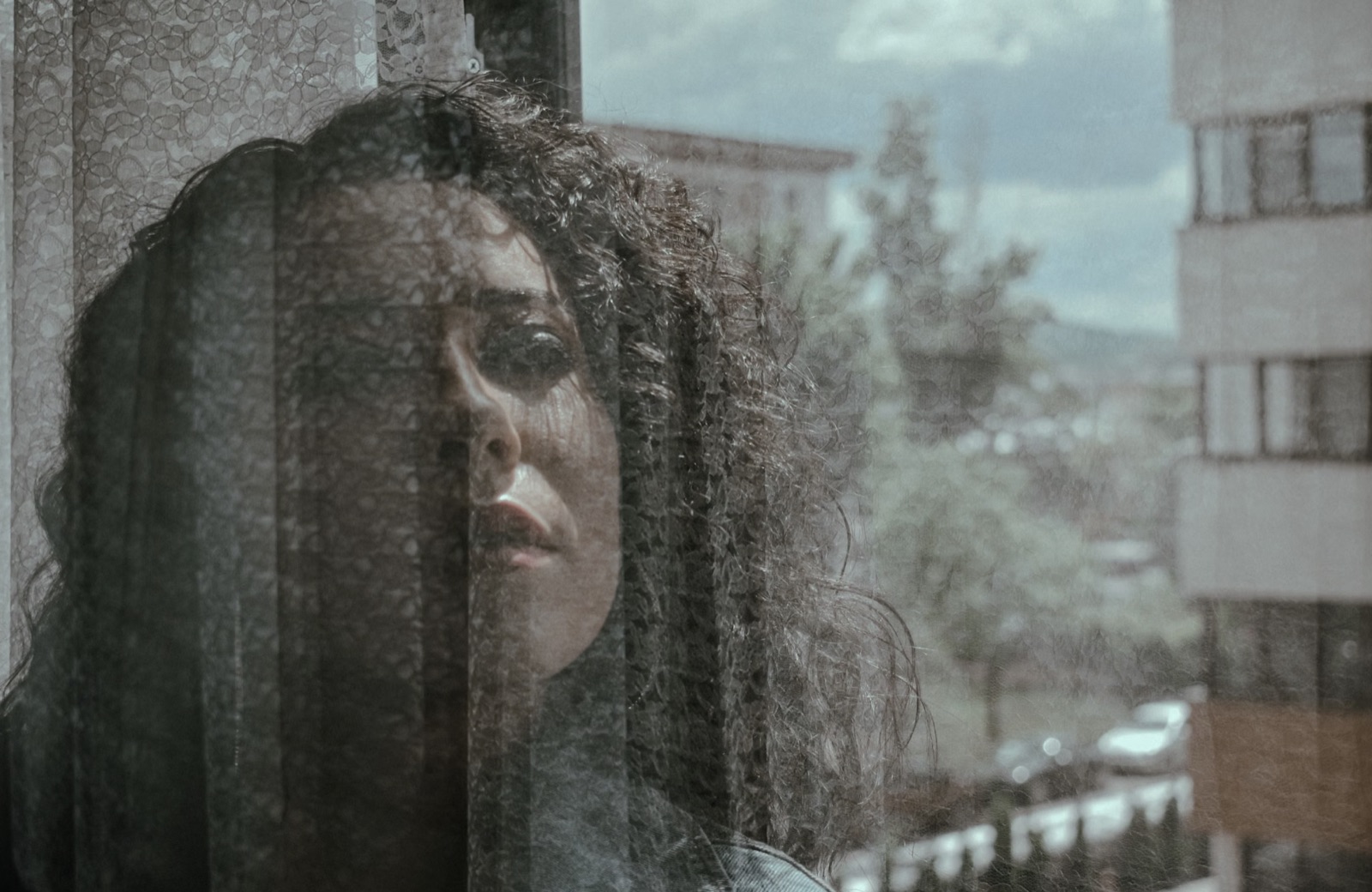 A woman pausing and reflecting by the window