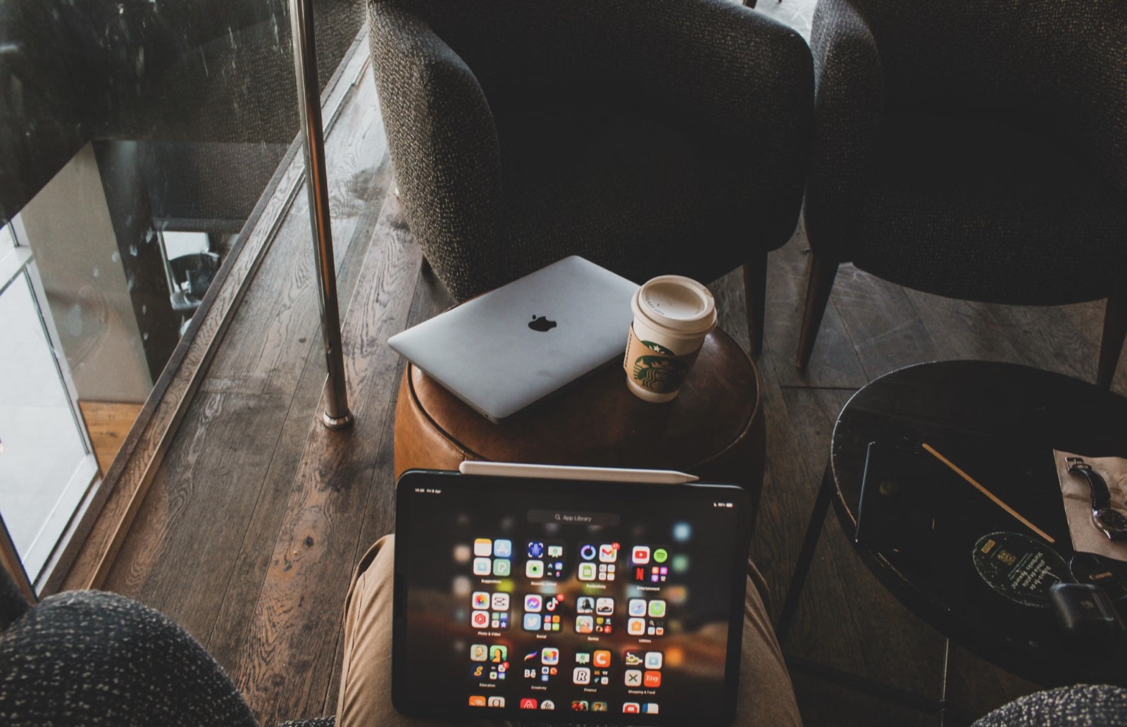 A laptop and notebook workspace for evaluating an online tarot tool