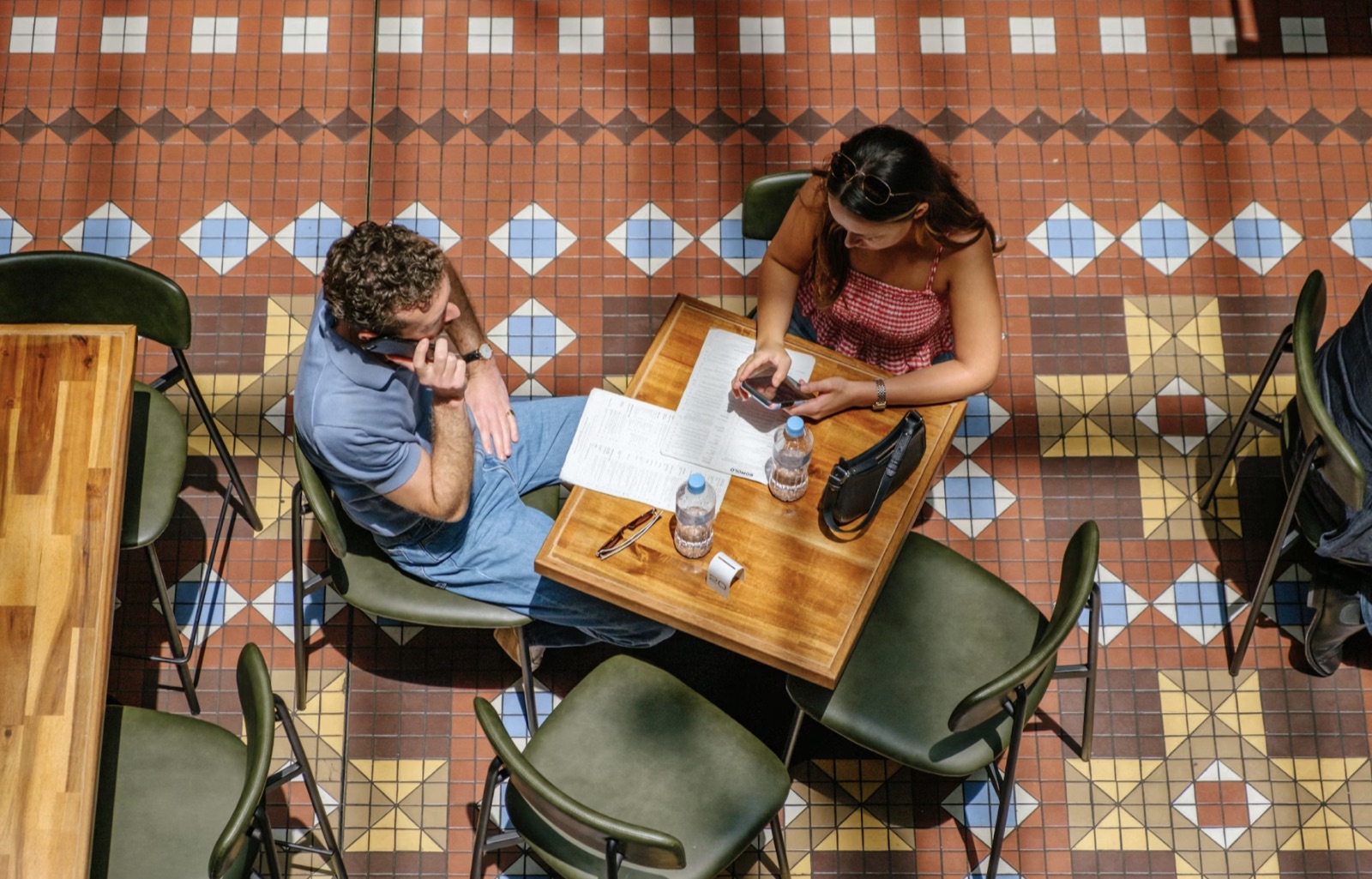 Two people talking at a cafe table, representing an honest relationship conversation.