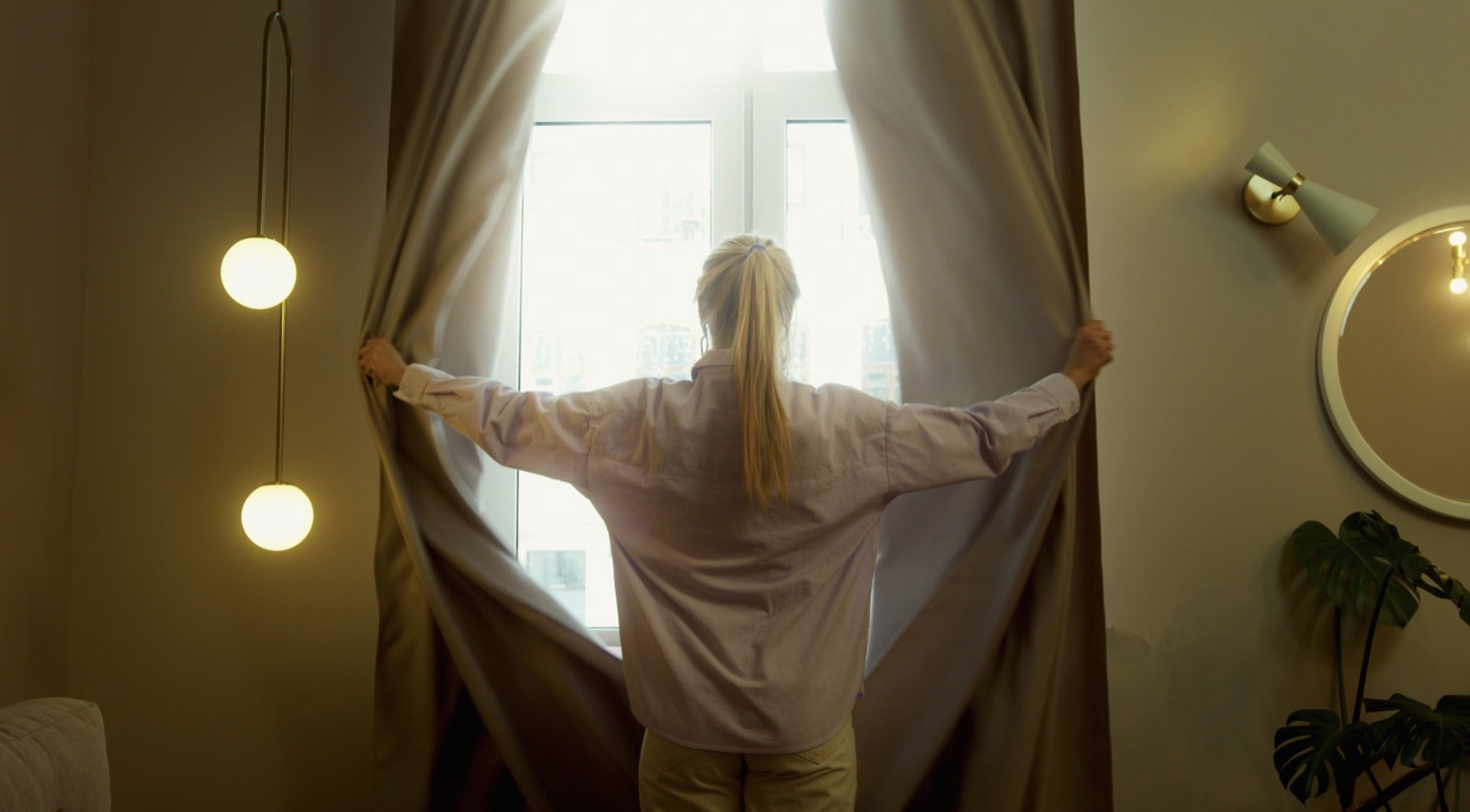 A person opening to morning light in a quiet room after a difficult period.