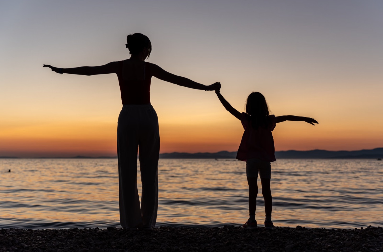 A warm family moment outdoors at sunset, reflecting belonging, harmony, and emotional fulfillment.