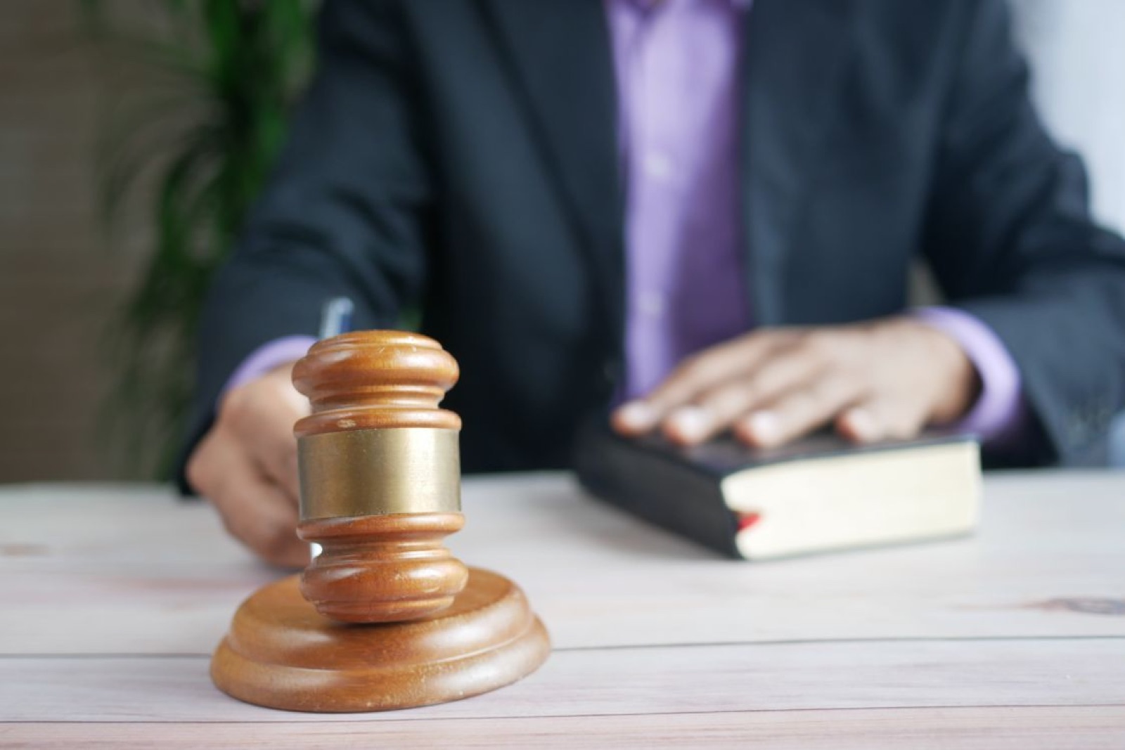 A gavel and legal book symbolizing judgment, authority, and the risk of distorted decisions.