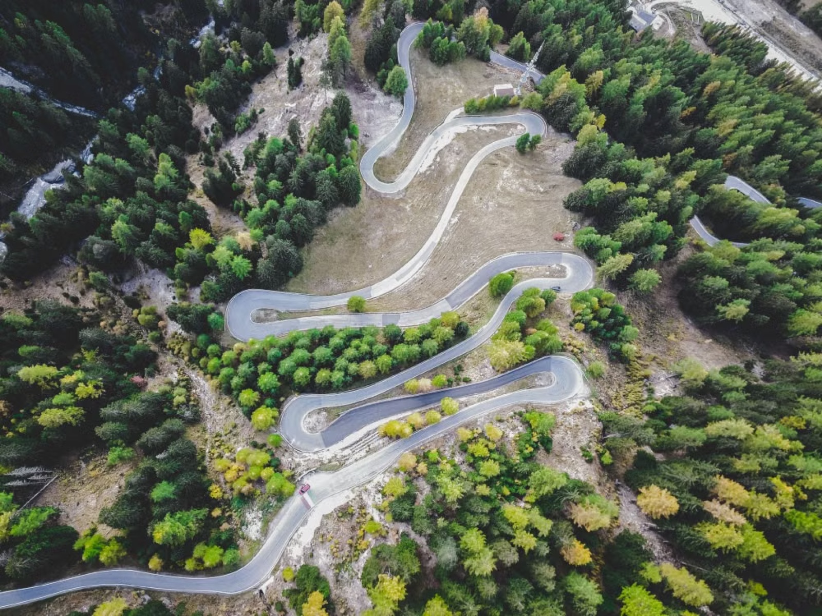 A winding road leading into distant mountains at golden hour, symbolizing a career path opening ahead.