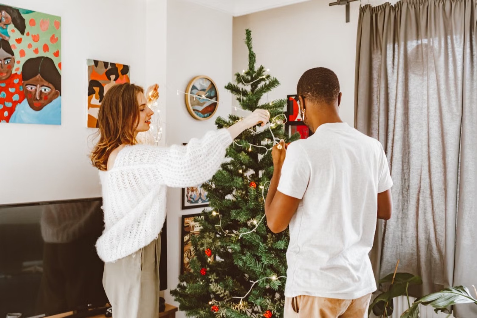 A couple building something together in a real-life home setting, symbolizing intentional relationship growth.