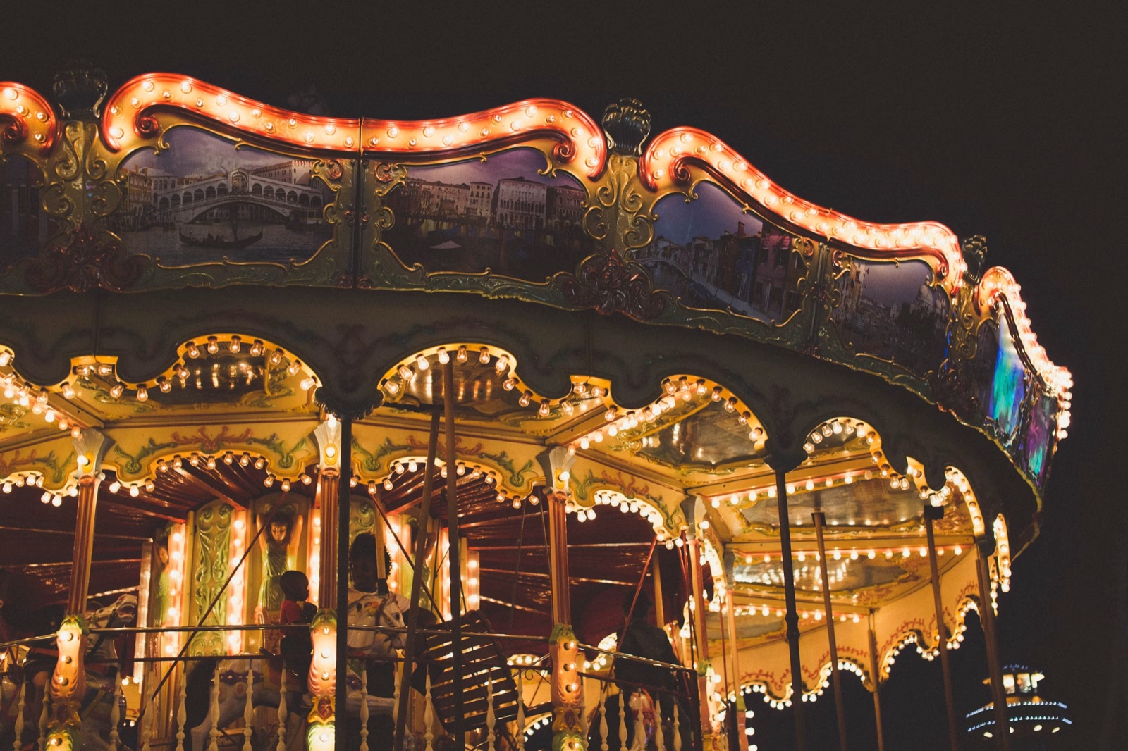 A warmly lit carousel at dusk, evoking nostalgia and childhood memories.