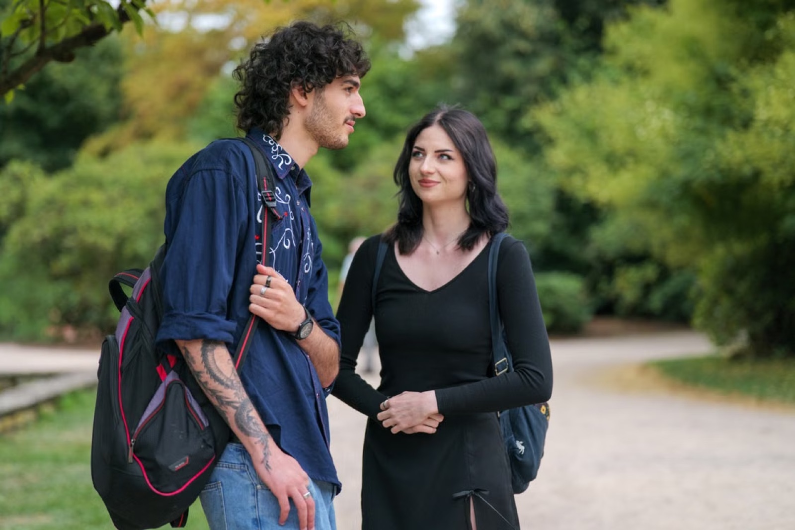 A couple walking and talking calmly outdoors, symbolizing honest communication and relationship repair.