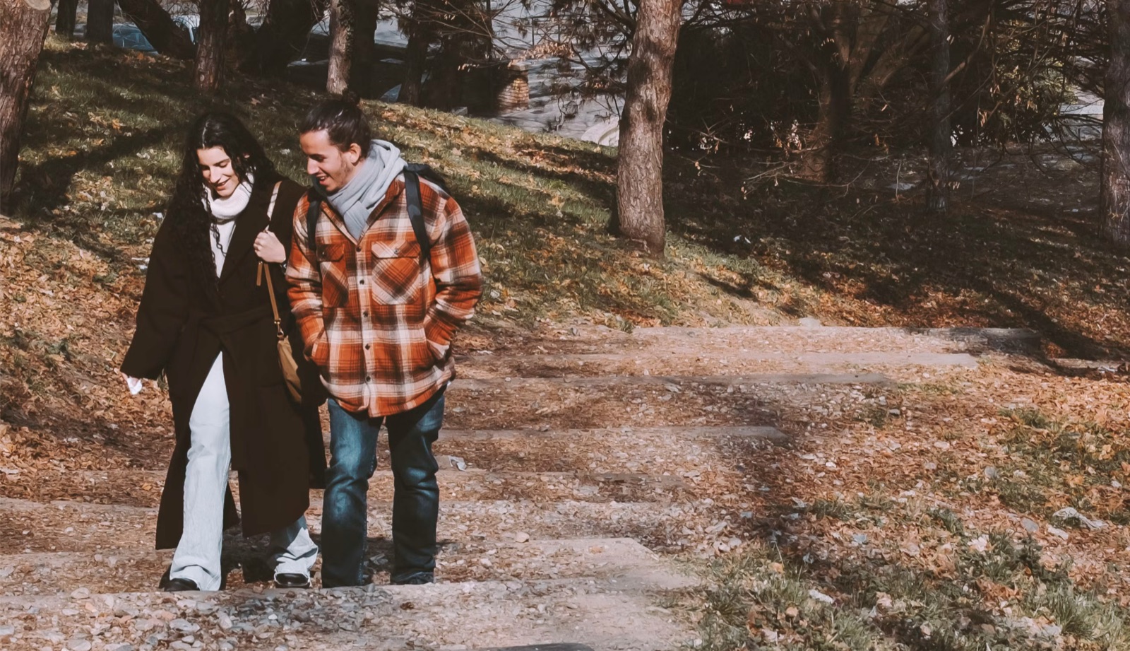 Two people naturally connecting outdoors, representing the early-stage chemistry and growing emotional interest shown by the Ace of Wands in love.