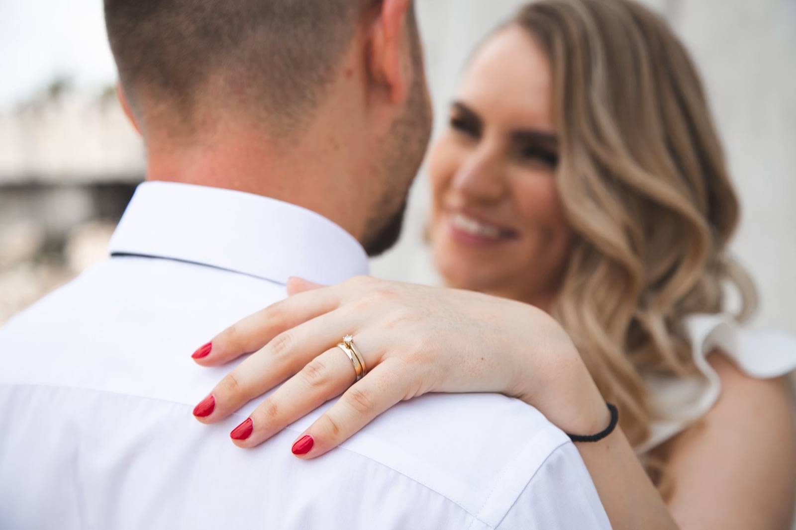 A couple outdoors with a wedding or engagement ring in focus, symbolizing commitment and a relationship moving toward something official.