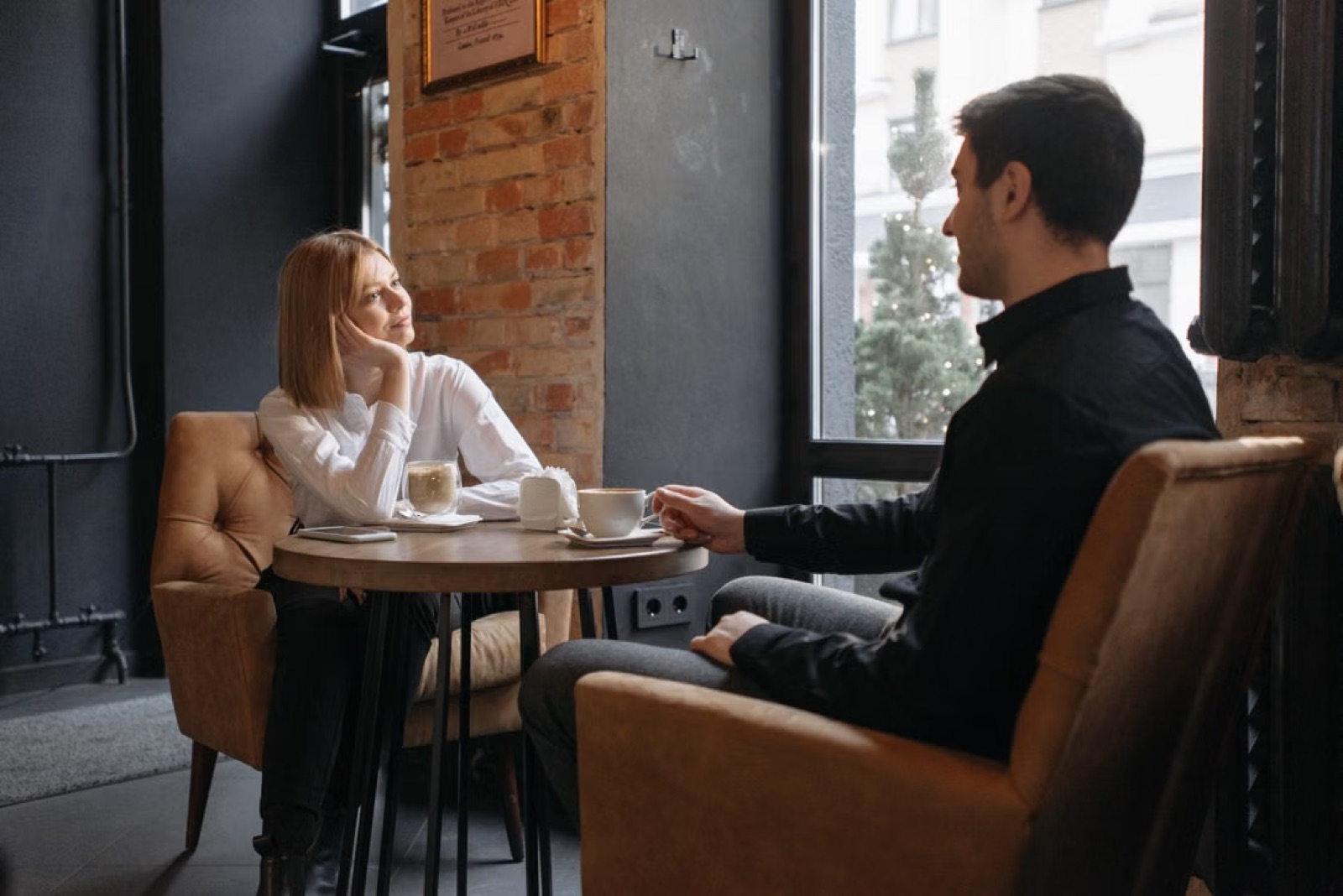 Two people having a calm, thoughtful conversation in a quiet setting.