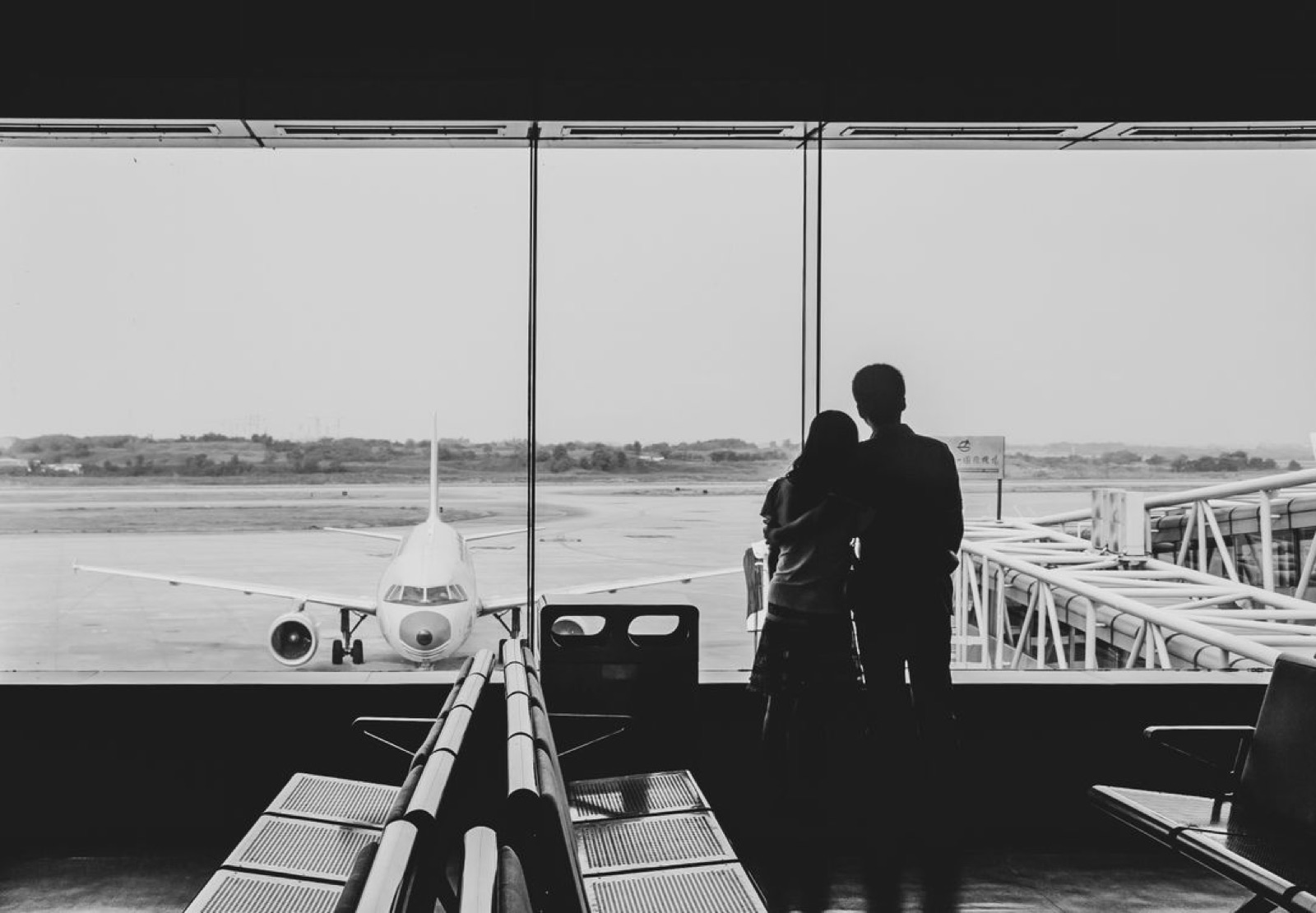 A real-life reunion at a train station or airport, with two people moving toward each other and a strong sense of timing and momentum.