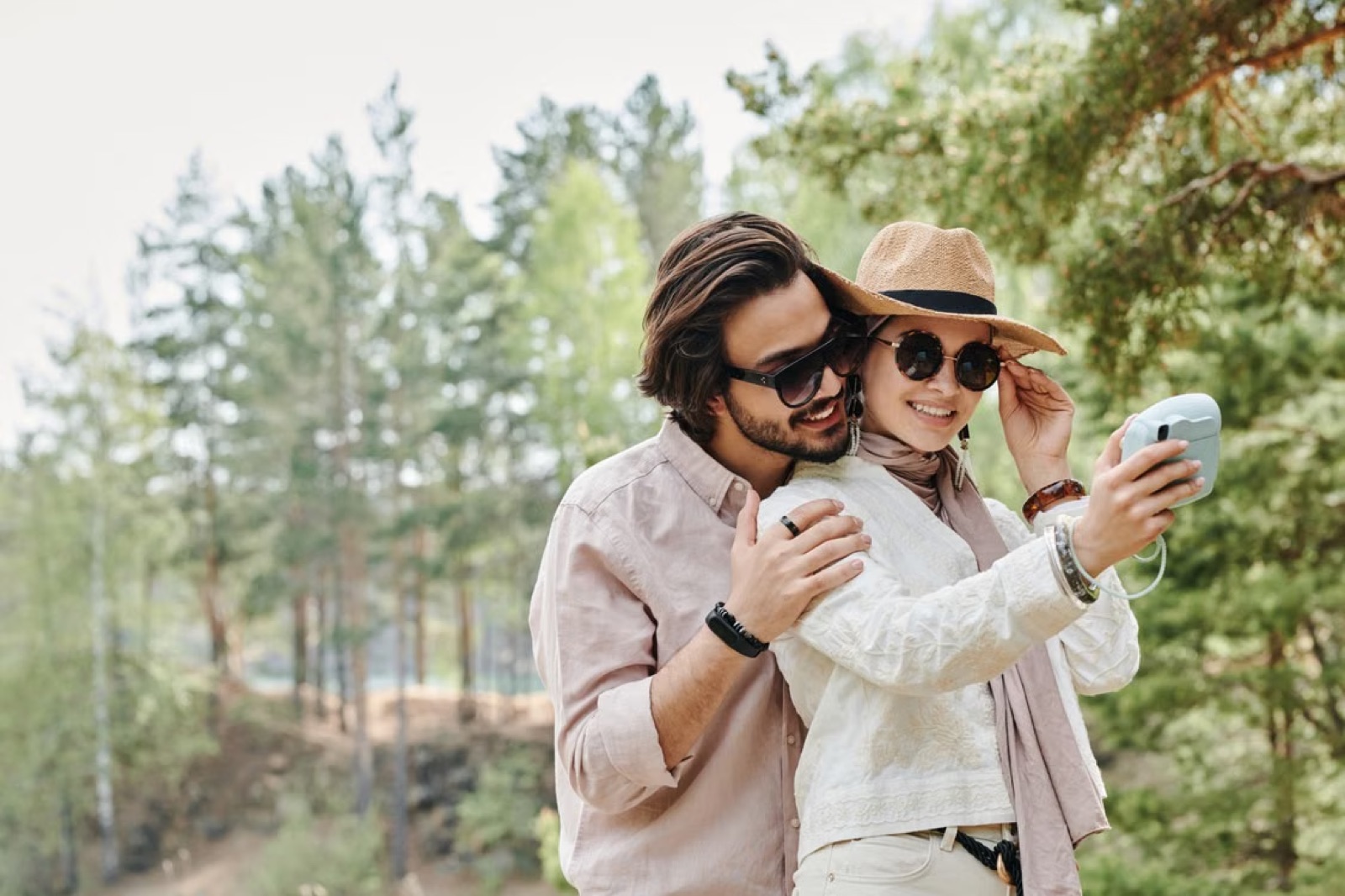 A couple at a celebration while one person seems especially aware of outside attention and social approval.