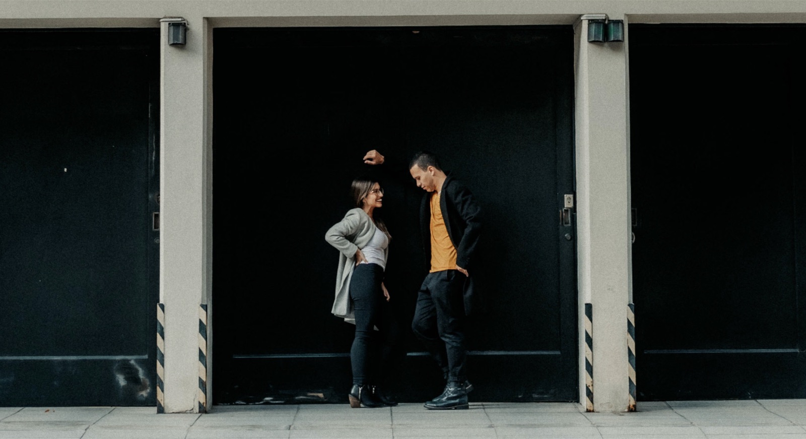 Two people in a real urban setting having a focused, direct conversation that reflects honesty, urgency, and emotional clarity.