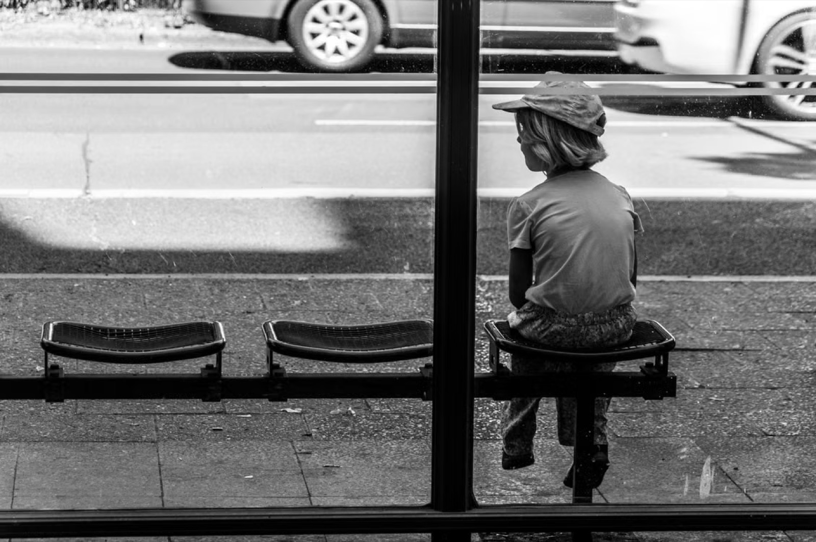 A person waiting alone in an everyday setting, expressing delay, fatigue, and a sense of life standing still.