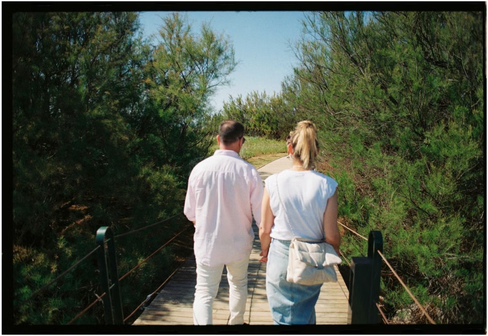 A couple walking naturally side by side or talking easily, with the relaxed intimacy of a relationship that has been chosen with intention.