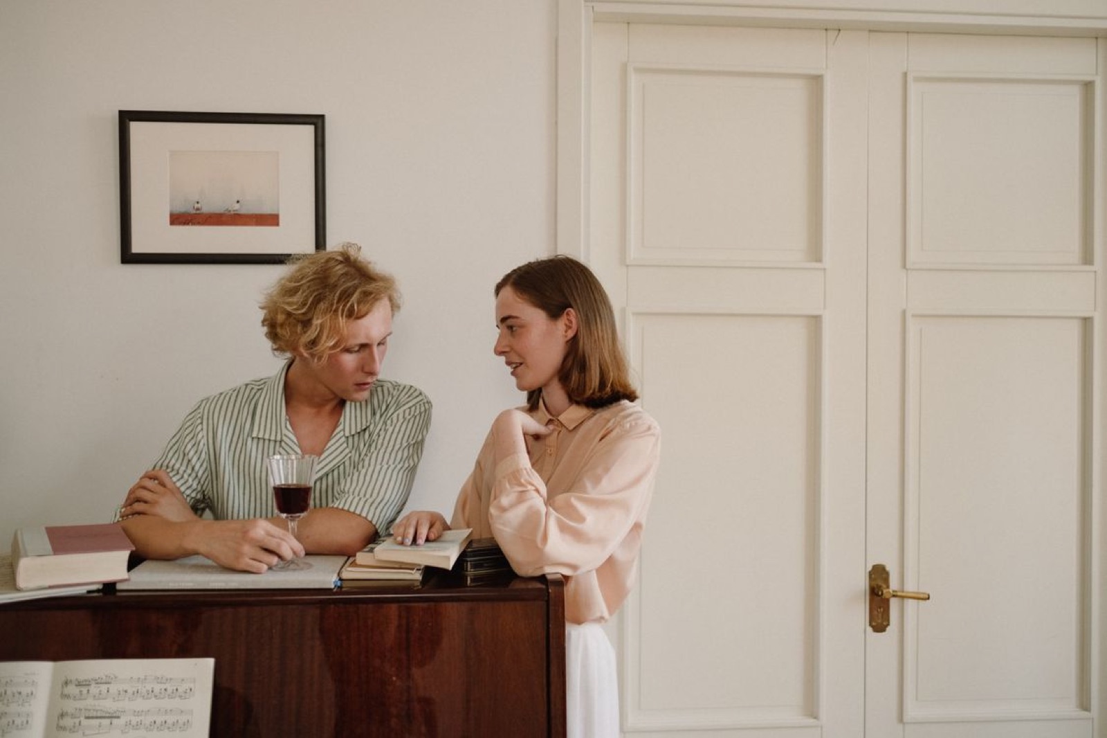 Two people sitting down in a real, everyday setting talking openly and listening to each other, with a calm, sincere atmosphere rather than drama.