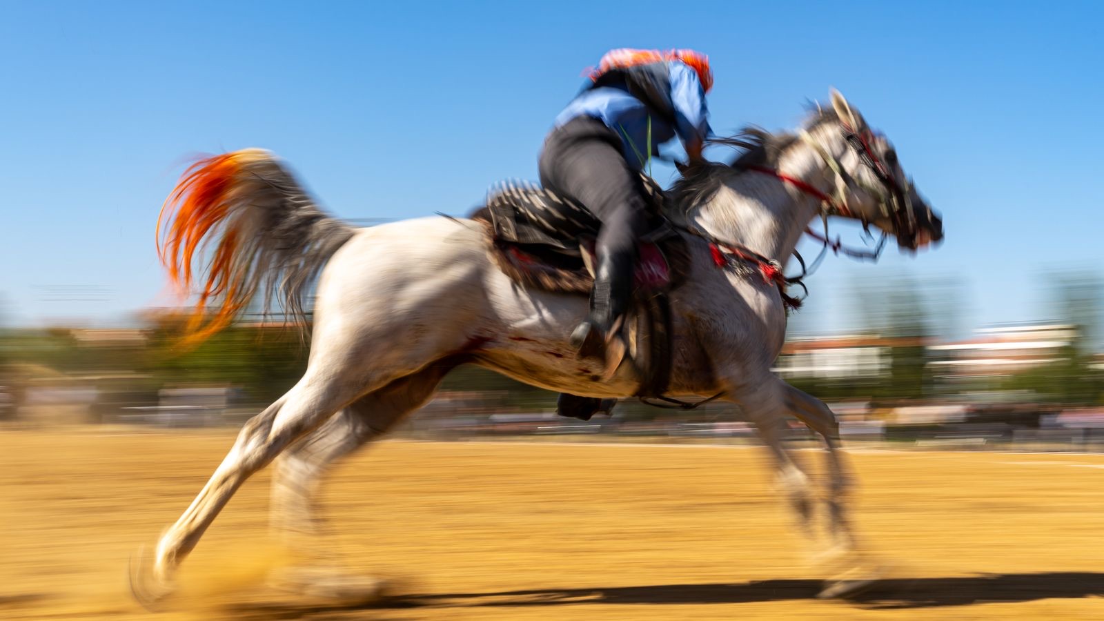 A rider on a galloping horse in motion, conveying speed and a decisive direction.