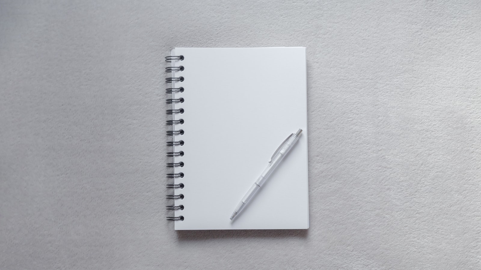 An open notebook with plans and a pen under warm light, conveying turning decisions into concrete steps.