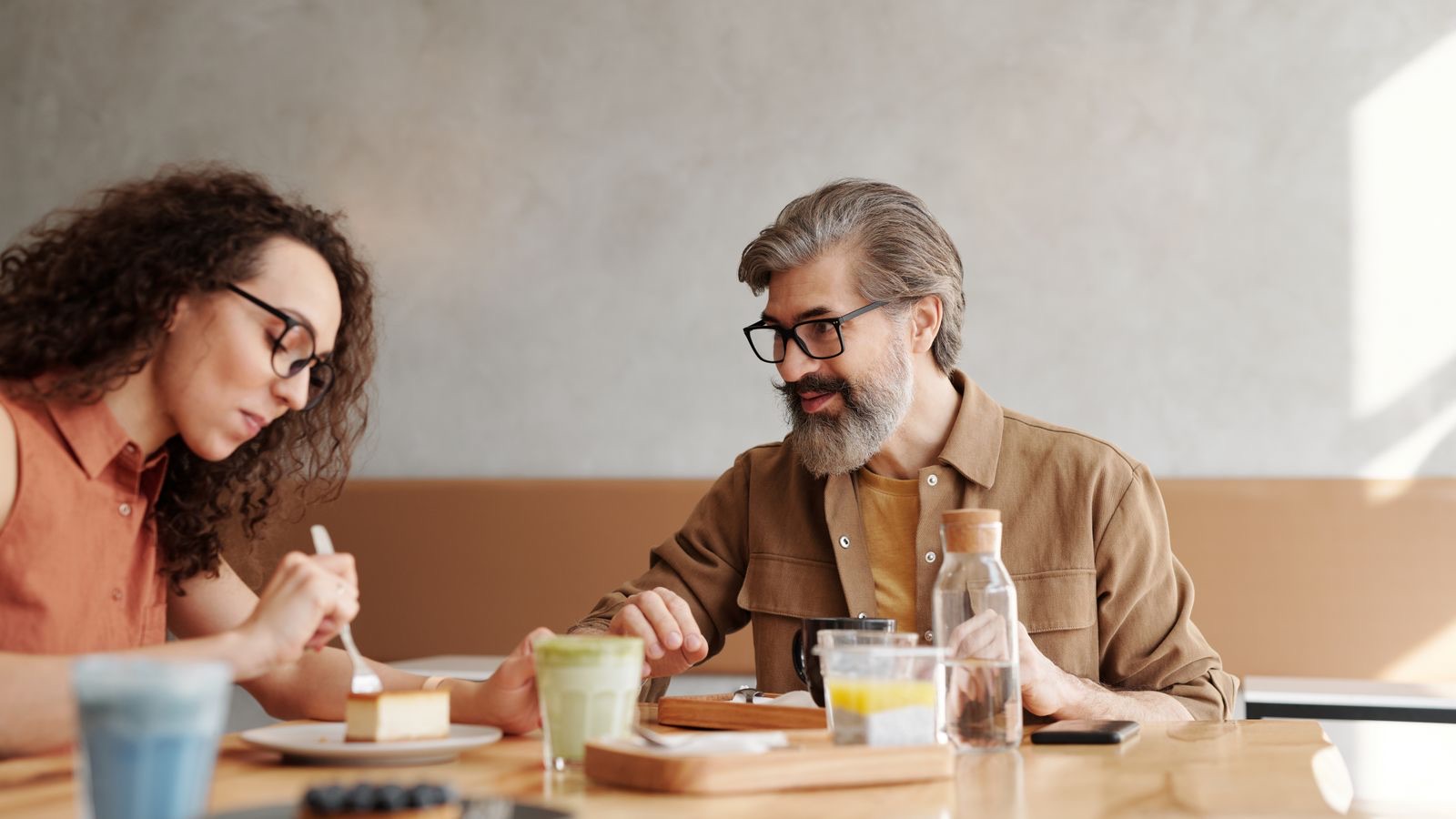 Two people talking honestly across a table, the fair and truthful dialogue of the King of Swords.